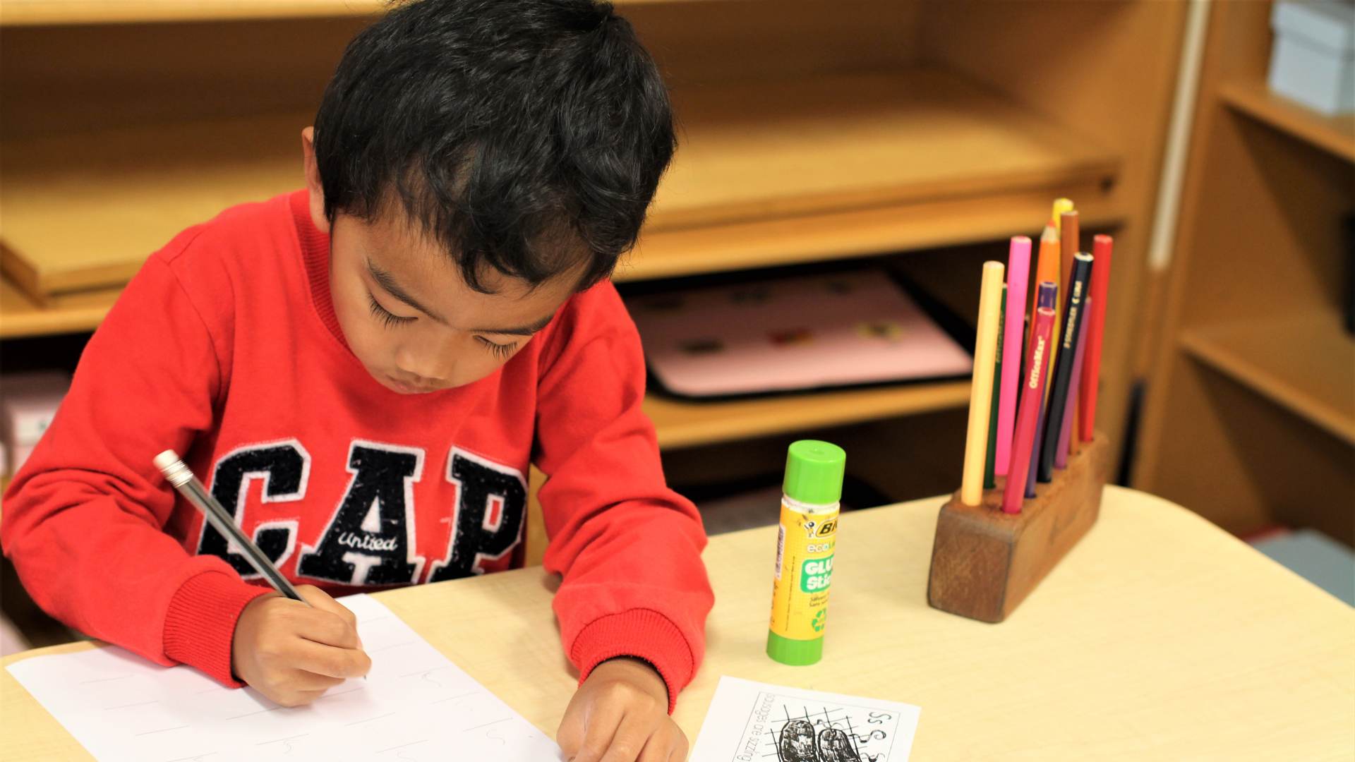 Boy learning to write at The Children's Corner Montessori Childcare Howick