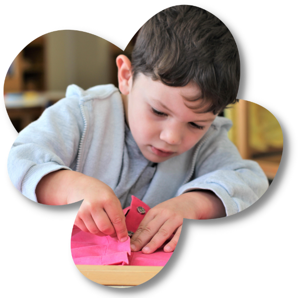 Boy learning to sew at The Children's Corner Montessori childcare centre in Howick, Auckland (1)