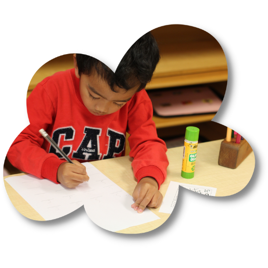 Boy learning to write at The Children's Corner Montessori childcare centre in Howick, Auckland (1)